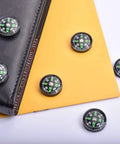 20 Pack Mini Pocket Oil Filled Compass 20mm Diameter Liquid Filled Grab And Go Navigation Tool shown on a notebook