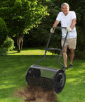 Man using 24 Inch Lawn Compost Spreader and Lawn Roller For No Fuss Topdressing Fertilizer And Seedling Care Lightweight Metal Mesh Tool