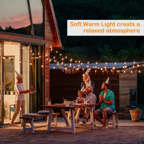 Outdoor LED String Lights 48ft Waterproof Patio Party Lights With Shatterproof Bulbs IP65 illuminating a backyard party table.