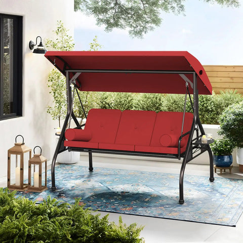 Red three seat outdoor porch swing with adjustable canopy, steel frame, thick cushions, and pillows for backyard hangout.