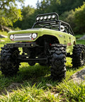 RC vehicle with Batwing Tread 58mm 1.0 Inch RC Crawler Tires 4 Pack For TRX4M SCX24 AX24 in outdoor rocky terrain.