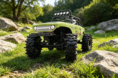 RC vehicle with Batwing Tread 58mm 1.0 Inch RC Crawler Tires 4 Pack For TRX4M SCX24 AX24 in outdoor rocky terrain.