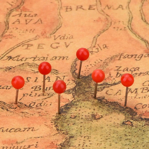 Top Shelf Office Upgrade Supercharge Your Daily Workflow With This Assorted 300 Piece Map Tack Set featuring red bead tops on a map.