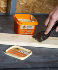 Gorilla All-Purpose Wood Filler, 16 oz tub, natural finish, applied to wood with putty knife