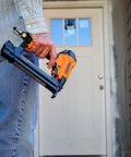 Person holding Next Gen Pneumatic 18 Gauge One And Five Eighths Inch Narrow Crown Stapler with Adjustable Metal Belt Hook.