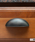 Oil Rubbed Bronze Cabinet Cup Pulls Three And A Half Inch Overall Length 10 Pack Durable Drawer Handles installed on wooden cabinet.