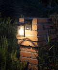 Coach Lantern Solar Outdoor Wall Light Fixture Sconce Black With Dusk To Dawn Lighting mounted on brick wall at night