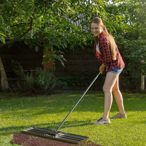 Person using Heavy Duty Lawn Leveling Rake 35 Inch With Stainless Steel Build And Full Welded Design Pro Grade Yard Care Tool in garden