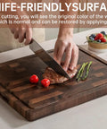 Top Shelf Solid Walnut End Grain Cutting Board Heavy Duty Kitchen Prep Surface With Deep Juice Channels 17X13X1 Inch in use with vegetables and meat.