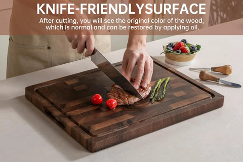 Top Shelf Solid Walnut End Grain Cutting Board Heavy Duty Kitchen Prep Surface With Deep Juice Channels 17X13X1 Inch in use with vegetables and meat.