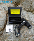 Ultra Bright EDC Flashlight 13000 Lumens, Rechargeable Pocket Light For Camping And Hiking, Emergency Prep, USB C Recharge, Compact 4.5 Inch Size, Long Lasting Battery shown with packaging and USB-C cable on rocky surface