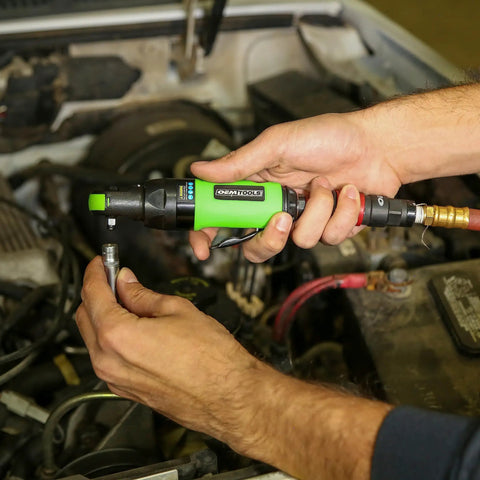 Quarter Inch Drive Air Ratchet With 700 RPM And 50 Ft Lb Torque being used in an engine bay for tight space access