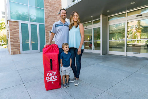 Family with Go To Gate Check Stroller Bag For Umbrella Strollers Travel Bag For Airplane Fits Most Single Umbrella Baby Strollers Airport Essentials For Gate Check Flying Essentials Red outside airport