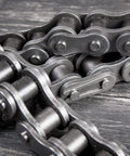 Close-up of Beefy Heavy Duty Roller Chain Three Eighth Inch Pitch With Six Point Three Five Millimeter Rollers, carbon steel for machinery.