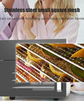 Real Deal Four Layer Stainless Steel Electric Food Dehydrator With Zero Sweat Temperature Control and Cool Touch Top showcasing small mesh racks with fresh fruit slices.