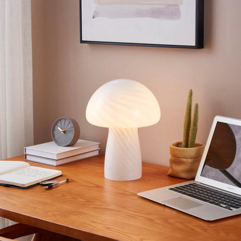 Mushroom Glass Table Lamp 12.75 Inch for Bedside Tables and Desks with warm white glow on wooden desk with laptop and clock.