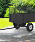 Beefy Steel Utility Trailer With 17 Cu Ft Bed And 750 Lb Load Capacity with removable sides and pneumatic tires on a path
