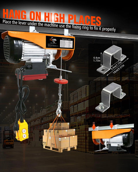 Electric hoist mounted to a beam with orange housing and yellow remote, 880 lb capacity lifting a pallet of boxes.