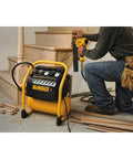 Person using Quiet Portable Nail Gun Air Compressor With 2.5 Gallon Tank, 200 PSI Max, Oil Free Pump for trim work on staircase.