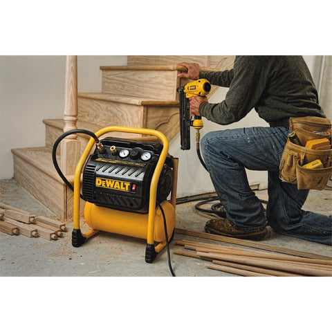 Person using Quiet Portable Nail Gun Air Compressor With 2.5 Gallon Tank, 200 PSI Max, Oil Free Pump for trim work on staircase.