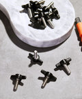 16 Piece Set Of 1/4 20 X 3/4 Inch Round Knob Bolts Made From Top Grade Stainless Steel Thumb Screws on a marble surface.