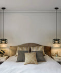 Bedroom setting with two farmhouse pendant lights with wood and metal cage, rustic white wood pendant with glass above nightstands.
