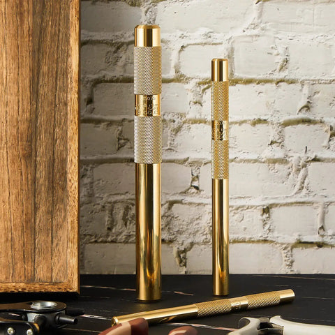 Brass Drift Punch Set, 3 Piece, Three Sizes Three Quarter Inch, One Half Inch, and Three Eighth Inch, on a workbench