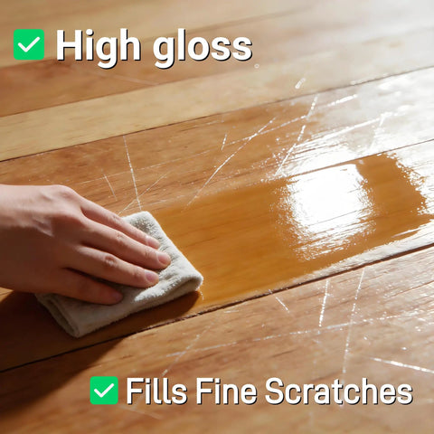Hand applying Top Shelf Wood Floor Restorer And High Gloss Polish For Fresh Slick Shine to wood floor, highlighting high gloss and scratch filling.