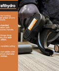Cordless Ratcheting Cable Cutter in use, cutting metal pipe, featuring comfort grip handle and alloy steel blades.