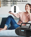 Woman using remote with Retro Boombox CD Player And Cassette Player Combo With Bluetooth USB TF Card FM Radio AUX AC DC