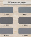 6-grit samples of 5 Inch Wet Dry Sanding Discs Hook And Loop 60 Pcs Silicon Carbide Grit 400 600 800 1000 1500 2000 on wood surface