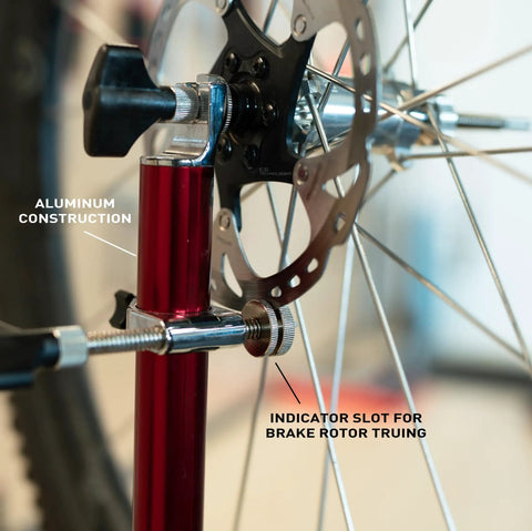 Close-up of Pro Truing Stand With Thru Axle Adapter Compact Portable Aluminum Single Arm Design showing indicator slot for brake rotor truing.