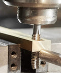 Dead Nuts 10-24 Thread Tap And Number 25 Drill Bit Combo Set For Right Hand Internal Threading being used on a metal workpiece.