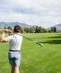 Golfer practicing with Pin Point Golf Swing Tempo Trainer And Warm Up Club With Flexible Shaft For Lag Training on green course