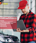 Man wearing a Baseball Bump Cap Hard Hat Helmet in red, working on a laptop near an open car hood in a workshop.