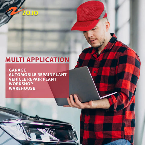 Man wearing a Baseball Bump Cap Hard Hat Helmet in red, working on a laptop near an open car hood in a workshop.
