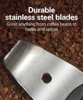 Close-up of stainless steel blades in the Fresh Grind Electric Coffee Grinder for Beans, Spices, and More with ground spices background.