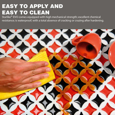 Hand wiping tiles with Starlike EVO Epoxy Grout For Tile Blue Denim 340 Easy To Apply No Fuss And Clean Bathroom Pool Backsplash Grout 2.5 Kg 5.5 Lbs Smooth Color Durable Finish Ideal For Porcelain Stoneware Glass Mosaic, beside red cups.