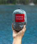 Go-To Nano 7 Ultra Light Hammock For Camping And Travel With Ripstop Nylon packed in hand by lake