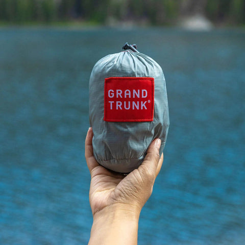 Go-To Nano 7 Ultra Light Hammock For Camping And Travel With Ripstop Nylon packed in hand by lake