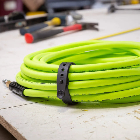 All Purpose Utility Strap 18 Inch Tie Down With 70 Lb Load Capacity holding neon green cable on workbench