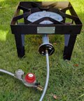 Propane regulator with 12-ft braided hose and 30 PSI gauge connected to outdoor burner on black metal stand