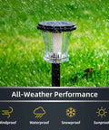 Lit Glass Solar Torch Lights Outdoor Waterproof Flickering Flame Tiki Torches With Modular Design in rain demonstrating all-weather performance.