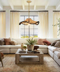Hodevimall 19.6" Boho Rattan Pendant Light Fixture above a cozy sectional sofa in a bright living room.