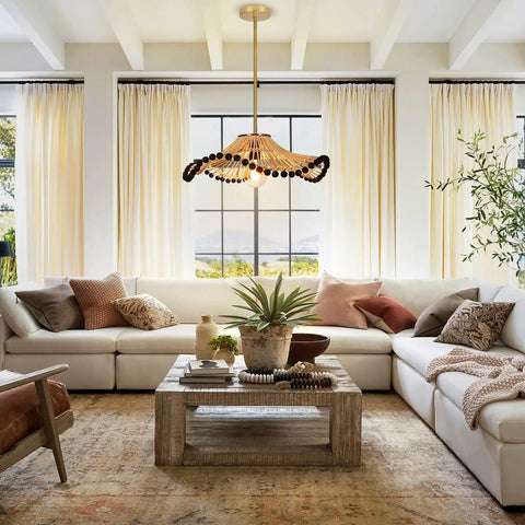 Hodevimall 19.6" Boho Rattan Pendant Light Fixture above a cozy sectional sofa in a bright living room.