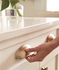 Golden Champagne Ashby Cabinet Cup Pull for 3 Inch Center To Center and 4 Inch Center To Center Spacing, installed on white drawer