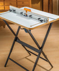 Rock Solid Router Table Kit With Powder Coated Steel Stand And Smooth Phenolic Plate in workshop setup for precision routing.