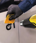 FURNO 700 Digital Heat Gun With 2 Nozzles, Adjustable 125 To 1300 F Temperature, used for paint stripping on car surface by gloved hand.