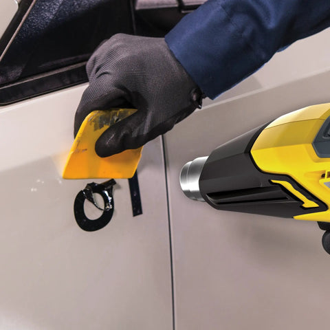 FURNO 700 Digital Heat Gun With 2 Nozzles, Adjustable 125 To 1300 F Temperature, used for paint stripping on car surface by gloved hand.