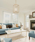 Antique Gold Four-Light Modern Linear Chandelier With Openwork Geometric Frame in living room setting over marble table